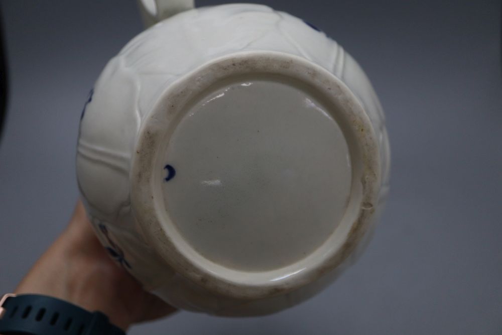 A Caughley cabbage leaf mask jug, c.1780, with scroll handle, decorated with floral sprays in underglaze blue, crescent mark, height